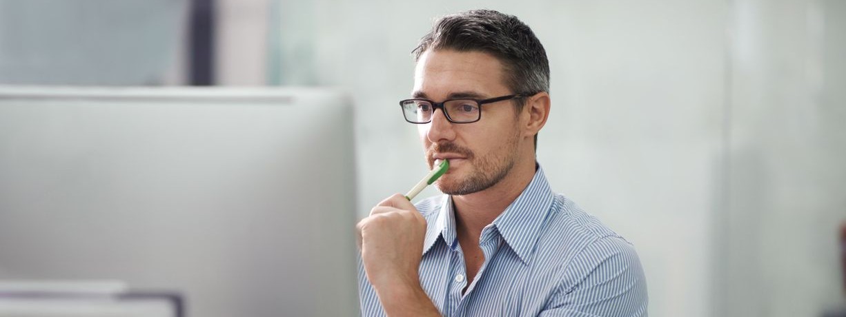 A cropped shot of a handsome businessman working at his desk