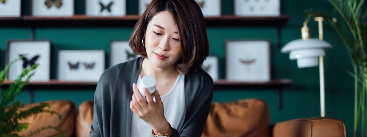 Eine Frau prüft Ihre Tabletten nach Nebenwirkungen